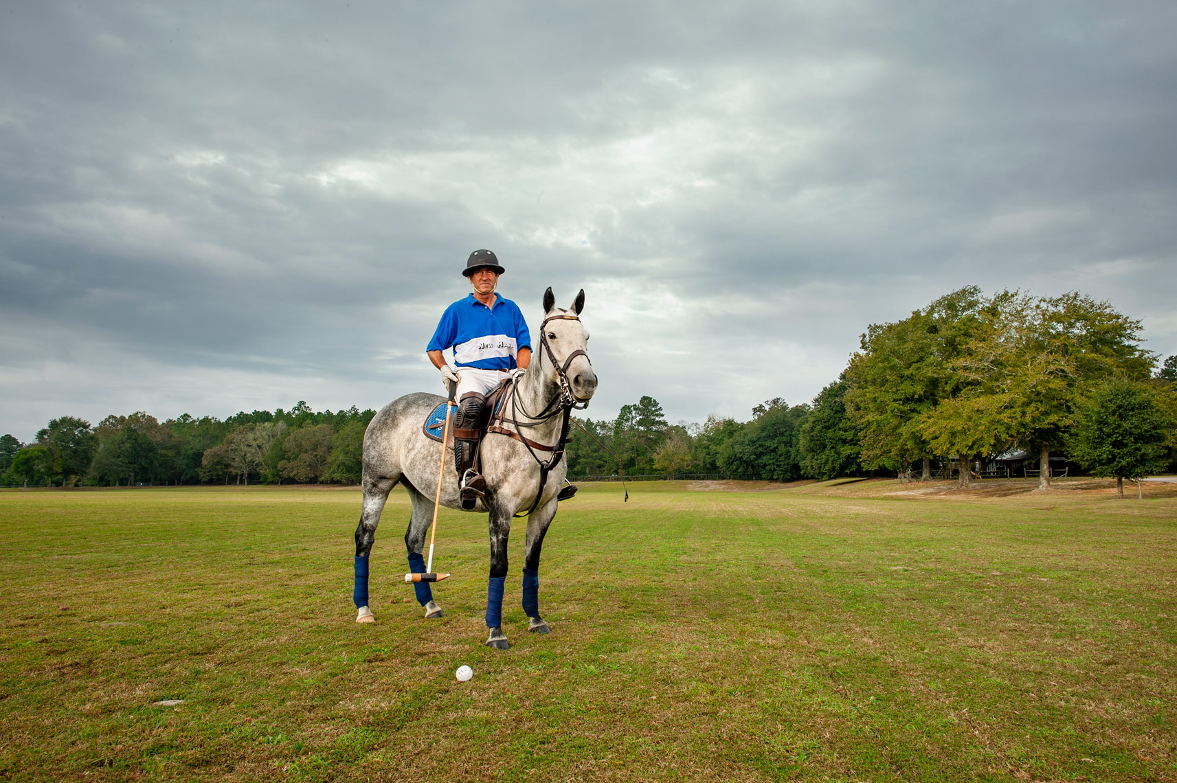 Ten Goal American Polo player Adam Snow and his horse stand for a portrait